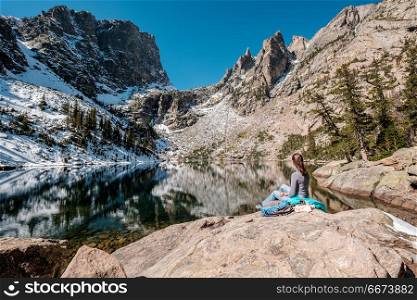 Tourist near Emerald Lake in Colorado. Woman tourist near Emerald Lake at autumn in Rocky Mountain National Park. Colorado, USA.