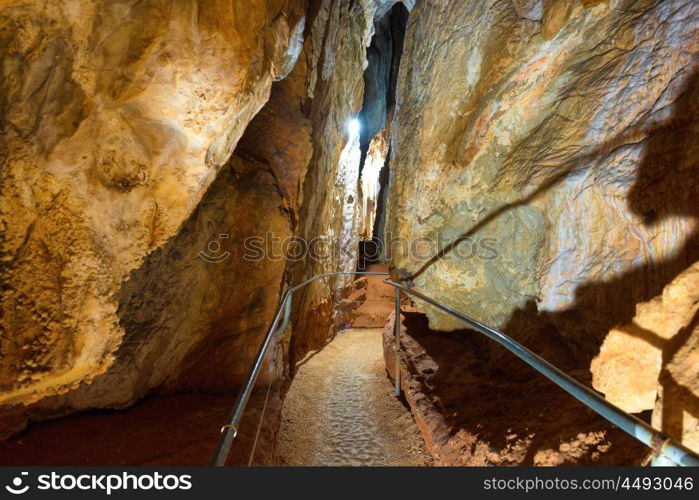 Tourist path in a beautiful old dark cave with many stalactites. Grotte di Is Zuddas, Italy, Sardinia