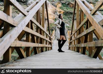 Tourist posing on a wood bridge near a forest in Galicia, Spain