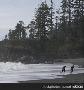 Tourist running on beach, Pacific Rim National Park Reserve, Tofino, Vancouver Island, British Columbia, Canada