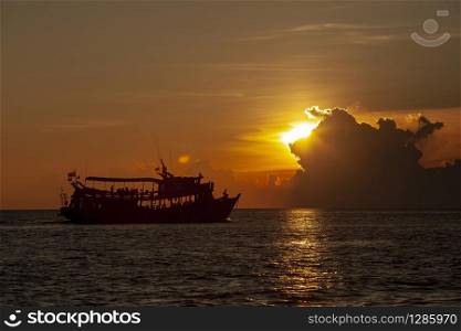 tourist scuba diving boat floating at koh tao harbor one of most popular traveling destinaiton in southern of thailand against beautiful sunset sky
