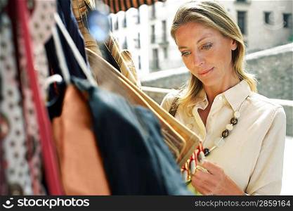 Tourist Shopping for Bags on Stall
