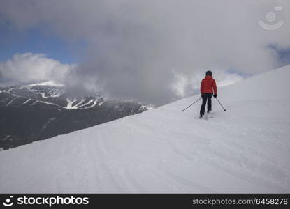 Tourist skiing on snowy mountain, Whistler, British Columbia, Canada