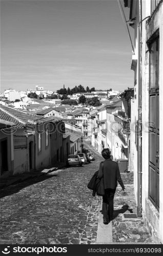 Tourist strolling along the cobbled streets of the historic old city of Braganca, Portugal