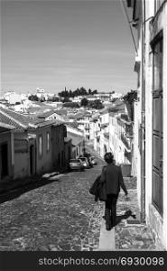 Tourist strolling along the cobbled streets of the historic old city of Braganca, Portugal