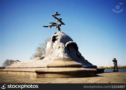 Tourist taking a photograph of a sculpture, Navy and Marine Memorial, Virginia, USA