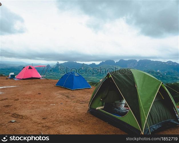 Tourist tent camping on mountains with rain storm and cloudy sky background, Doi Tapang, Sawi District, Chumphon, Thailand.