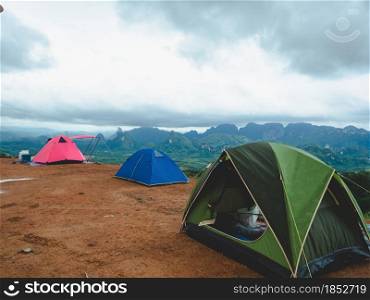 Tourist tent camping on mountains with rain storm and cloudy sky background, Doi Tapang, Sawi District, Chumphon, Thailand.