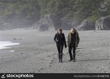 Tourist walking on beach, Pacific Rim National Park Reserve, Tofino, Vancouver Island, British Columbia, Canada