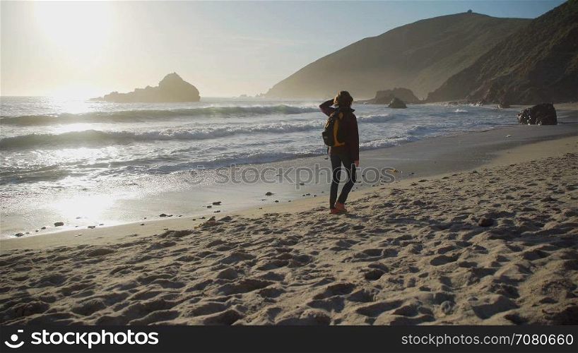 Tourist walks along Pfeiffer beach