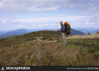 tourist with a backpack on the background of the mountains 