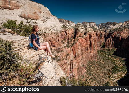 Tourist with backpack hiking in Zion National Park, Utah, USA