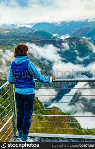 Tourist woman enjoying morning mountain view. River Sil Canyon in Parada de Sil, Galicia Spain. View from Cabezoa lookout. Relax on nature, mental freedom, stress heal.. Tourist woman enjoy mountain view. River Sil Canyon, Spain