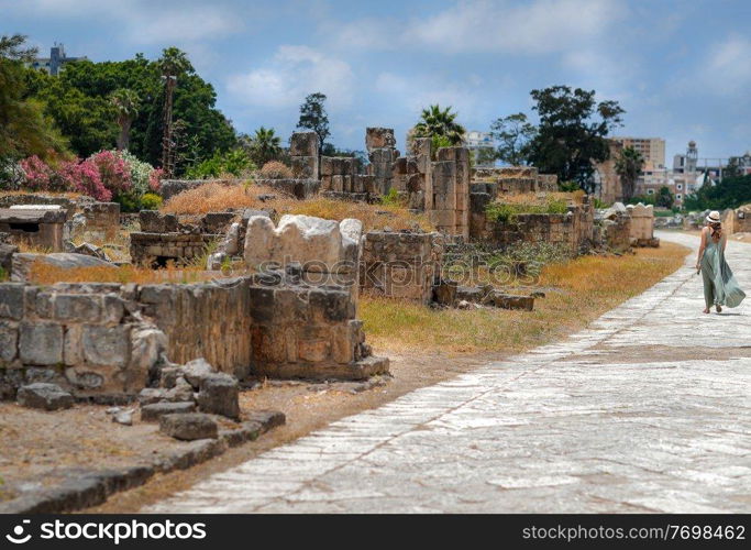 Tourist Woman Walking Along Ruins - Landmark of Tyre. Enjoying Beauty and Majesty of Necropolis. Exploring Ancient Architecture. Travel to Lebanon. World Heritage.