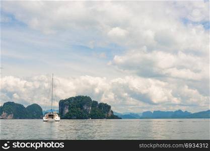 tourist yacht in a beautiful bay with steep cliffs in Thailand