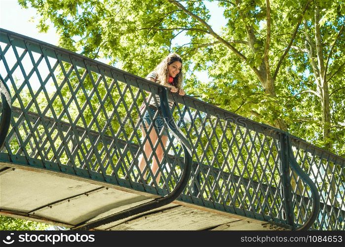 Tourist young woman on the bridge in a beautiful park.