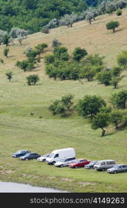 touristic camp: vehicles parked at the meadow. vehicles parked at the meadow