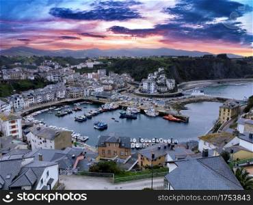Touristic destination Luarca, Asturias, Spain, Europe. Nature urban landscape with fishing and pleasure port with boats at sunset.