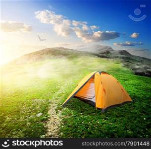 Touristic tent in mountain valley in spring
