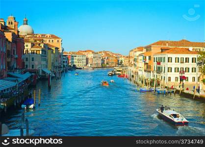 Tourists and locals chilling in cafe and touring Venice streets on boats enjoying the view