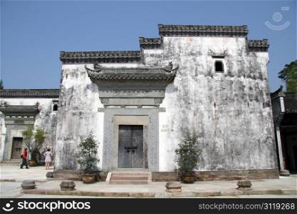 Tourists and old white houses in Shexian town, China