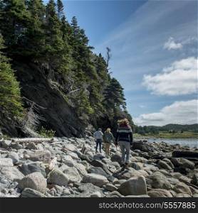 Tourists at rocky coast, Norris Point, Bonne Bay, Gros Morne National Park, Newfoundland And Labrador, Canada