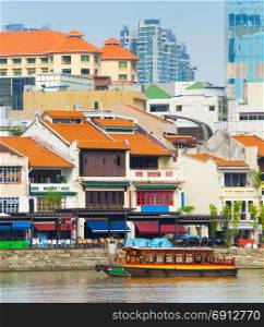 Tourists boat at Boat Quay - historical city part of Singapore