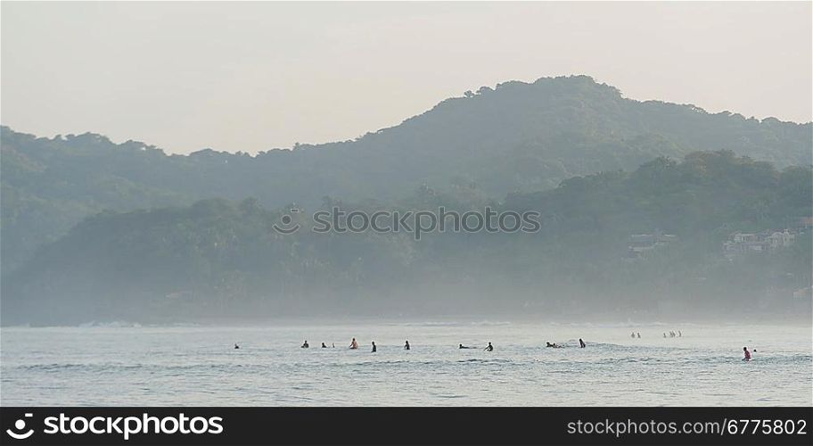 Tourists enjoying surfing in the sea, Sayulita, Nayarit, Mexico