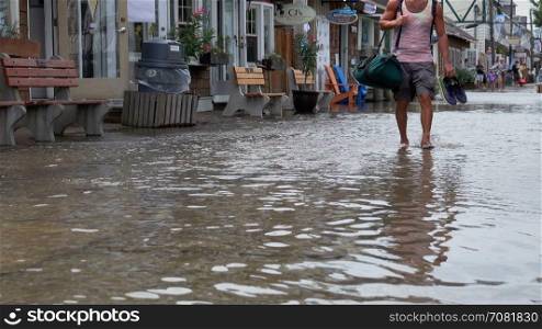 Tourists escape from a tidal surge