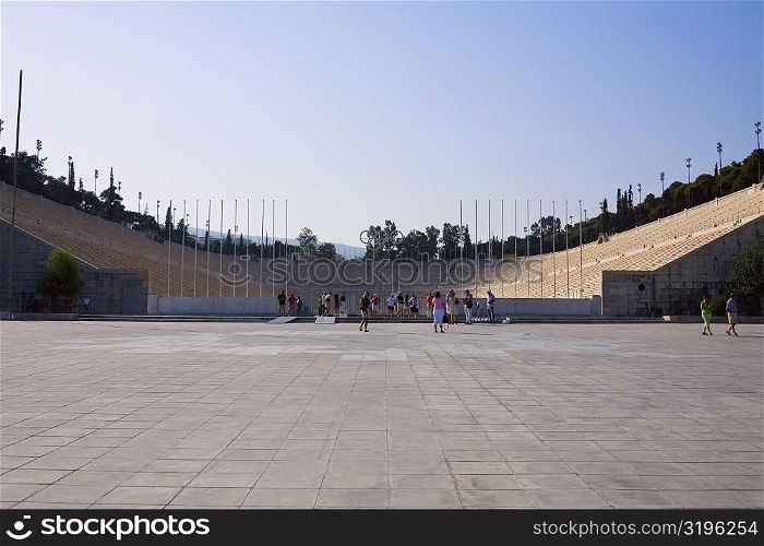 Tourists in an amphitheater, Theater Of Herodes Atticus, Acropolis, Athens, Greece