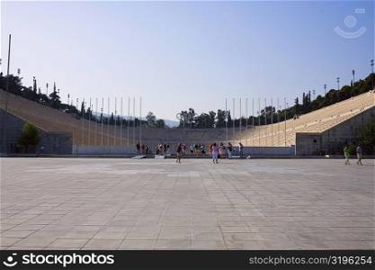 Tourists in an amphitheater, Theater Of Herodes Atticus, Acropolis, Athens, Greece