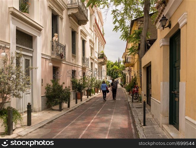 Tourists in ancient district or neighborhood of Plaka in Athens by the Acropolis. Ancient residential district of Plaka in Athens Greece