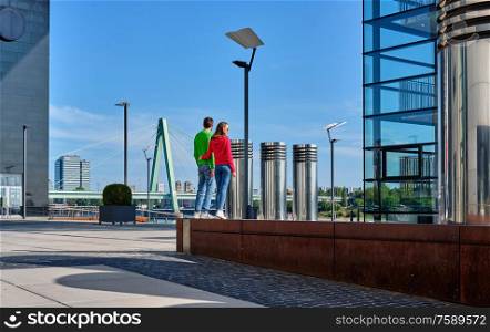 Tourists in Cologne near Kranhaus building complex with crane house on riverside of Rhein in Cologne, Germany.