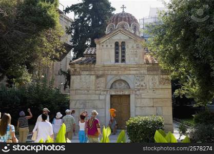 Tourists in front of a church, Panagia Gorgoepikoos, Athens, Greece