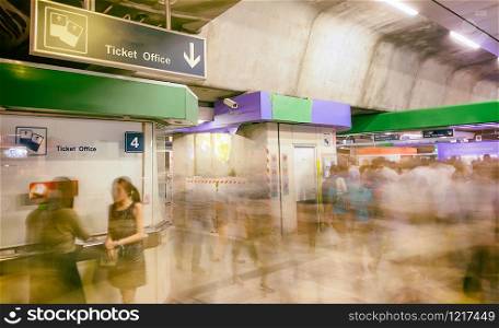 Tourists in the airport terminal, blurred view with fast moving people. Holiday and travel concept.