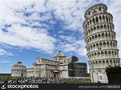 Tourists in the Piazza dei Miracoli, having from left to right the Baptistry, the Cathedral and the Bell Tower.