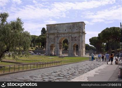 Tourists near a triumphal arch, Arch Of Constantine, Rome, Italy