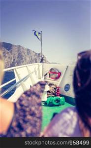 Tourists on a boat tour. Blue sky, white ship bow. Lago di garda, Italy