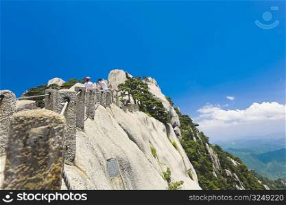 Tourists on a cliff, Huangshan, Anhui province, China