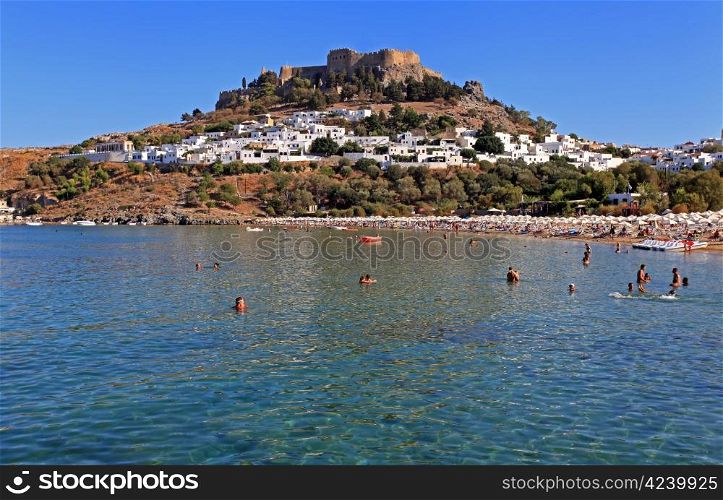 Tourists on Lindos Beach in the summer months