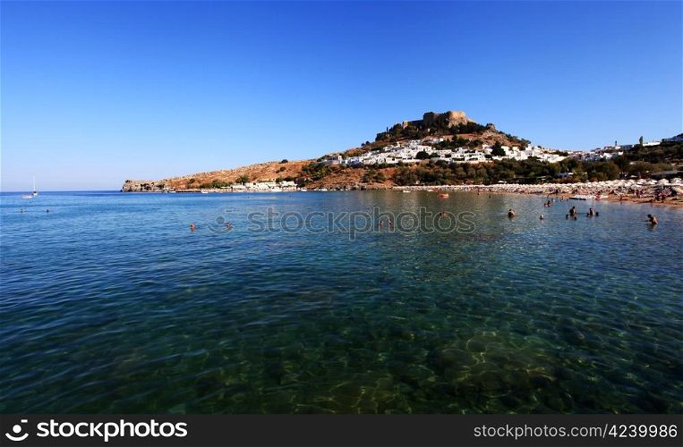 Tourists on Lindos Beach in the summer months