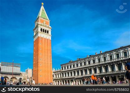 Tourists on San Marco square with Campanile and Doge Palace. Venice, Italy