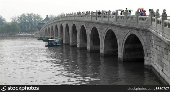 Tourists on Seventeen Arch Bridge, Kunming Lake, Summer Palace, Haidian District, Beijing, China