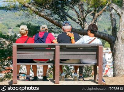 Tourists on the bench.. Elderly tourists have a rest on bench admiring the city.