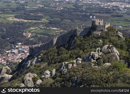 Tourists on the Castle of the Moors at Sintra near Lisbon in Portugal. The castle dates from the 10th century and is now a popular tourist destination. Sintra is known for its many 19th century Romantic monuments and is a UNESCO World Heritage Site.