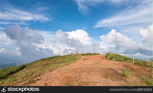 Tourists on the mound and blue sky with white cloud above high mountain at viewpoint of Phu Chi Fa Forest Park in Chiang Rai Province Thailand, 16:9 wide screen