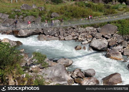 Tourists on the suspension bridge on the Annapurna trail in Nepal