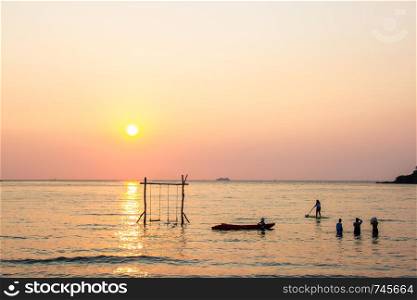 Tourists play in the water sea during the sunset at area ao bang bao Koh kood island Trat, Thailand.