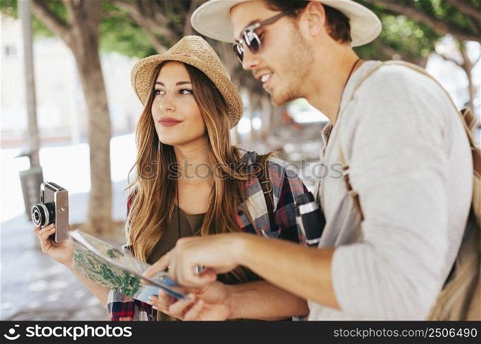 tourists posing with camera map