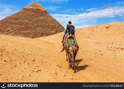 Tourists riding camels near the Pyramid of Khafre, Giza.. Tourists riding camels near the Pyramid of Khafre, Giza